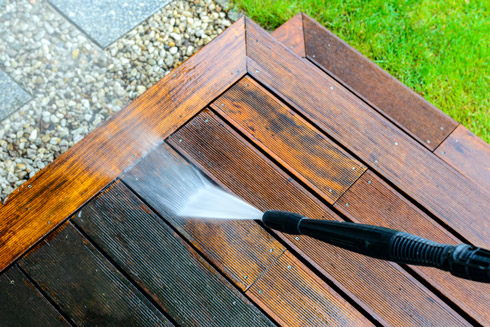 pressure washing wooden deck for cleaning and maintenance